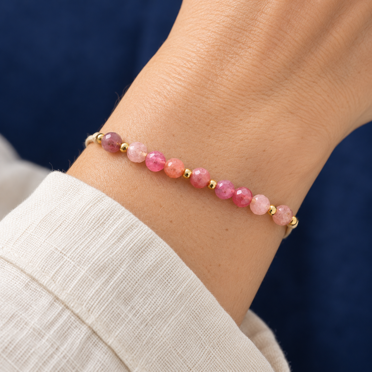 AI-generated on-body styling image of Birth Month Crystal Cord Bracelet — Curated By Suarez. Shown: October · pink crystal cord. Illustrative fit; see original product photos and measurements.