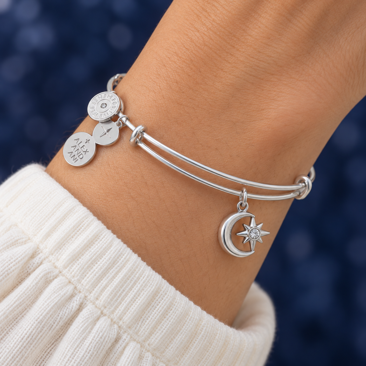 AI-generated on-body styling image of ALEX AND ANI Moon & Star Charm Bangle. Shown: Silver-tone bangle. Illustrative fit; see original product photos and measurements.