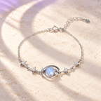 Alternate styled image: Starry Orbit silver bracelet on ivory stone with lilac moonlight. AI-created setting; original product photos also available.
